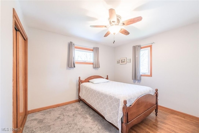 bedroom with a ceiling fan, baseboards, and a closet