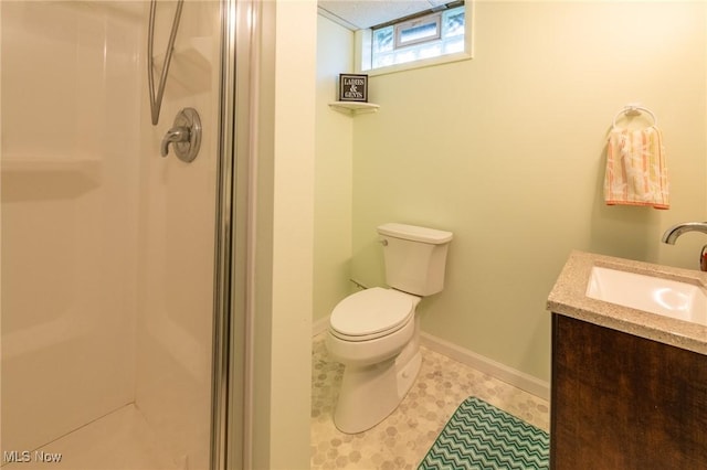 bathroom with a stall shower, tile patterned flooring, baseboards, and toilet