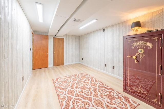 empty room with wood finished floors and visible vents