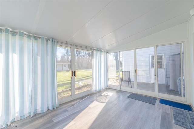 unfurnished sunroom with lofted ceiling