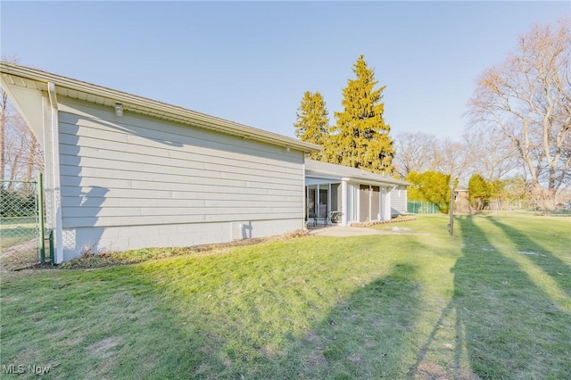 back of house with a lawn, fence, and a sunroom