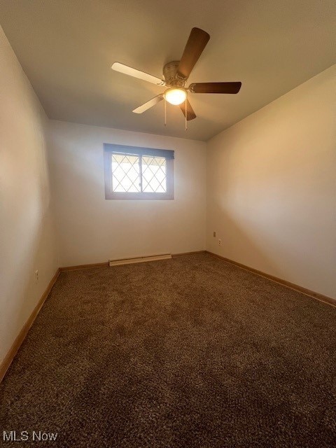 carpeted empty room with ceiling fan and baseboards