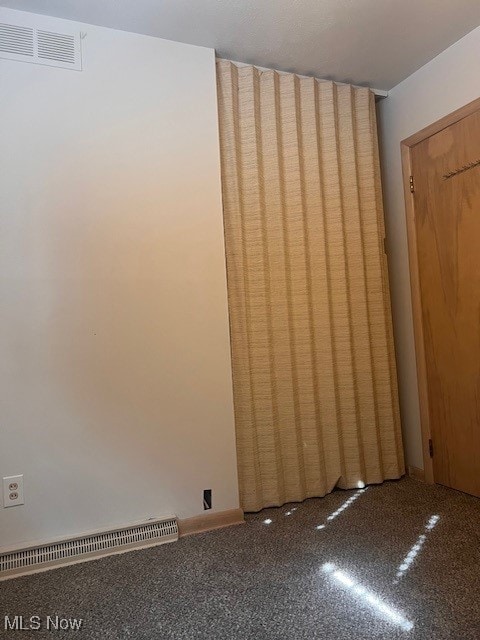 unfurnished room with visible vents