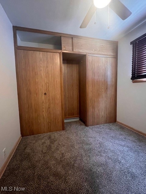 unfurnished bedroom featuring carpet flooring and baseboards