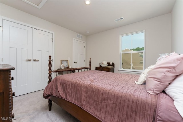 bedroom featuring a closet, carpet flooring, and visible vents