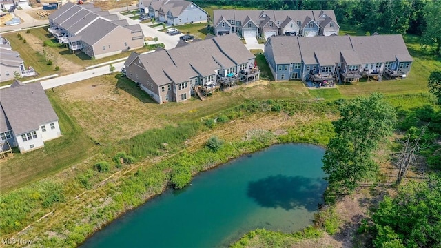 birds eye view of property with a water view and a residential view