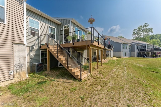 back of house with stairs, a yard, a wooden deck, and a residential view