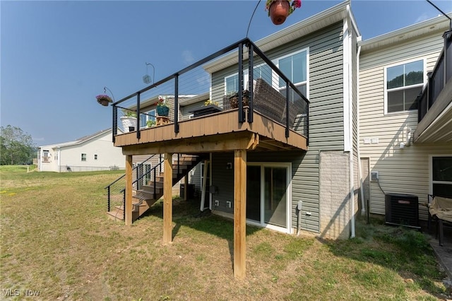 back of property with stairs, cooling unit, a lawn, and a wooden deck