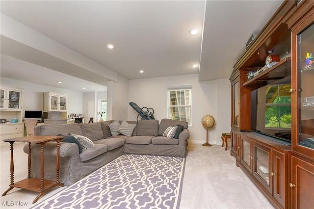 living area featuring baseboards, a healthy amount of sunlight, recessed lighting, and light colored carpet