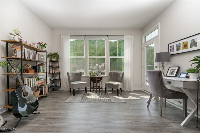 living area featuring baseboards and wood finished floors