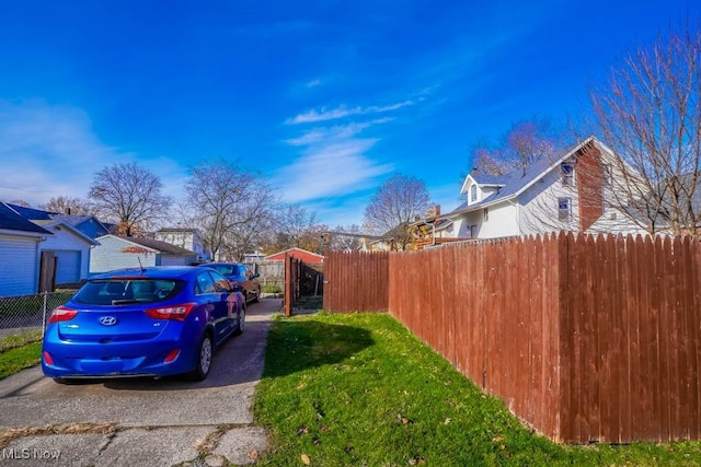 exterior space featuring a residential view and fence