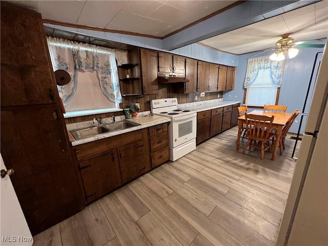 kitchen featuring light wood-style flooring, a sink, light countertops, open shelves, and white range with electric cooktop