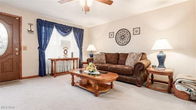 living area featuring a ceiling fan, carpet, and baseboards