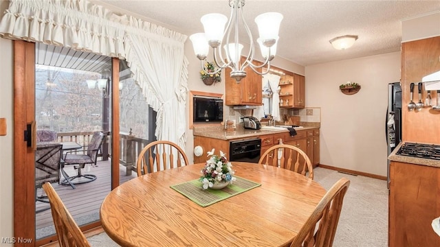 dining space featuring baseboards, a chandelier, a textured ceiling, and light colored carpet