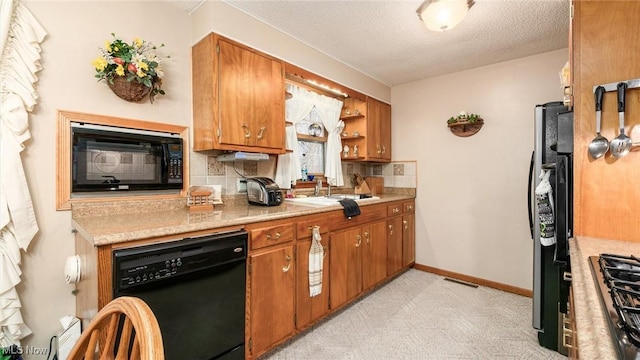 kitchen featuring black appliances, brown cabinets, backsplash, and light countertops