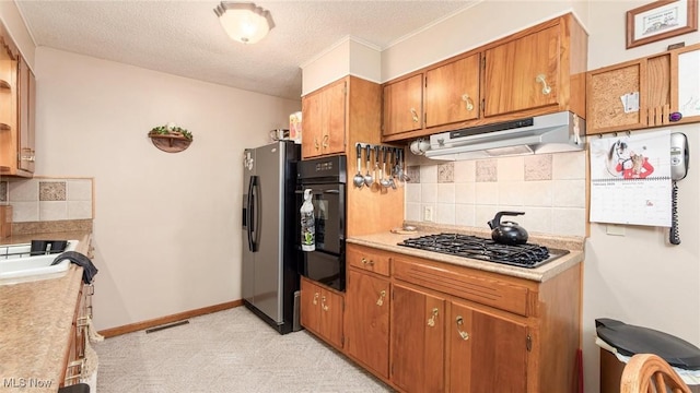 kitchen featuring oven, fridge with ice dispenser, under cabinet range hood, stainless steel gas stovetop, and backsplash