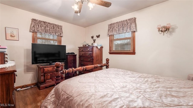 bedroom featuring baseboards and wood finished floors