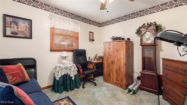 carpeted office space with ceiling fan