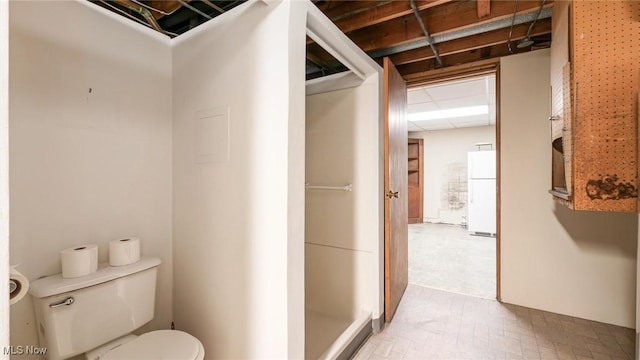 bathroom with toilet and a drop ceiling