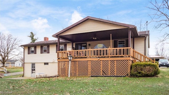 rear view of property featuring covered porch, a yard, and a chimney