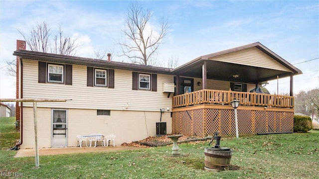 back of house featuring central AC and a yard