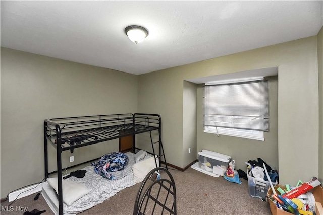 bedroom with carpet and baseboards