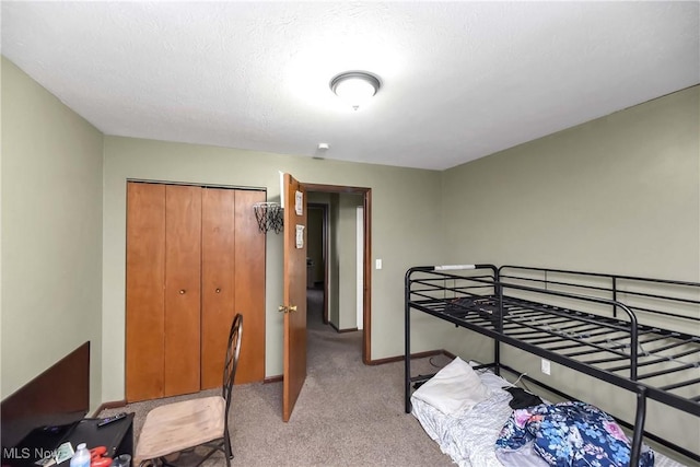 bedroom featuring a closet, light colored carpet, and baseboards