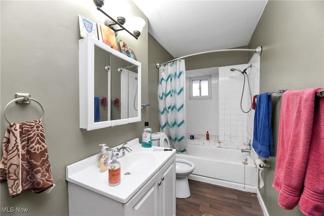 bathroom with toilet, wood finished floors, vanity, and shower / tub combo with curtain