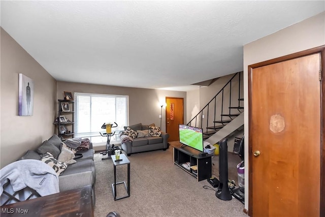 carpeted living room with stairs and a textured ceiling