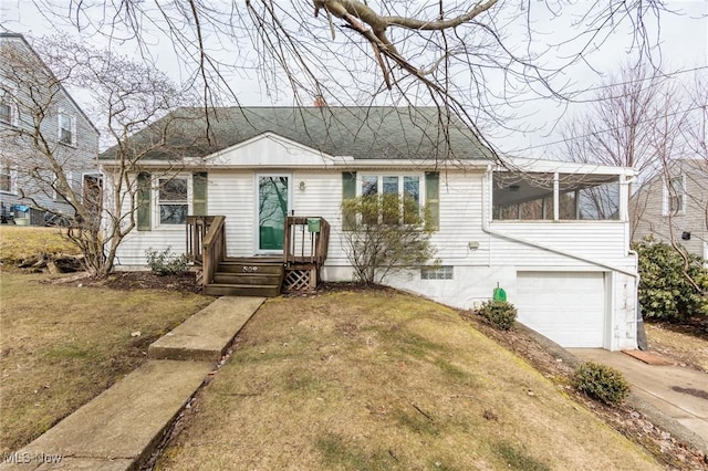 view of front of house with a garage, a front lawn, and concrete driveway