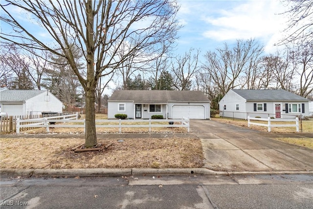 single story home featuring a garage, driveway, and a fenced front yard