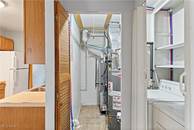 utility room featuring separate washer and dryer, gas water heater, and a sink