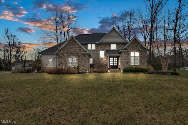 traditional-style house featuring a front yard