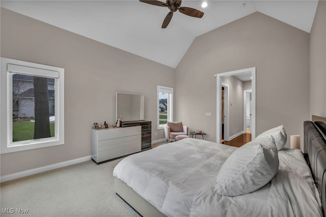 bedroom featuring high vaulted ceiling, light carpet, ceiling fan, and baseboards