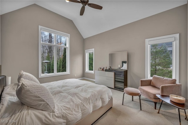 bedroom with vaulted ceiling, a ceiling fan, and light colored carpet