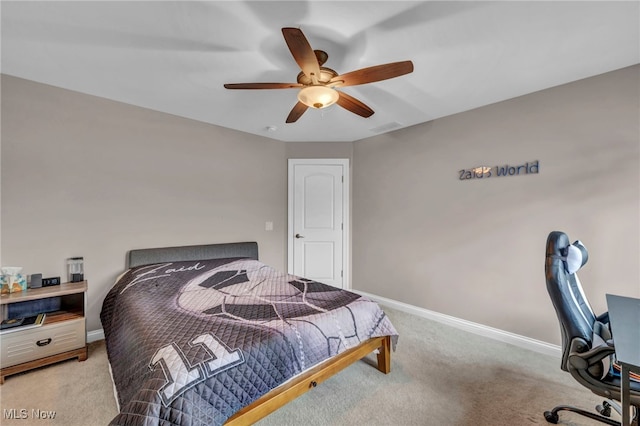 bedroom with light carpet, ceiling fan, visible vents, and baseboards