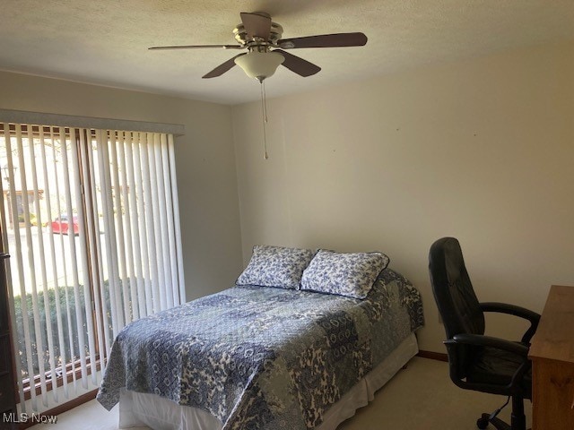 703 Tournament Trl, Cortland, OH 44410 - bedroom featuring a textured ceiling, carpet floors, and ceiling fan