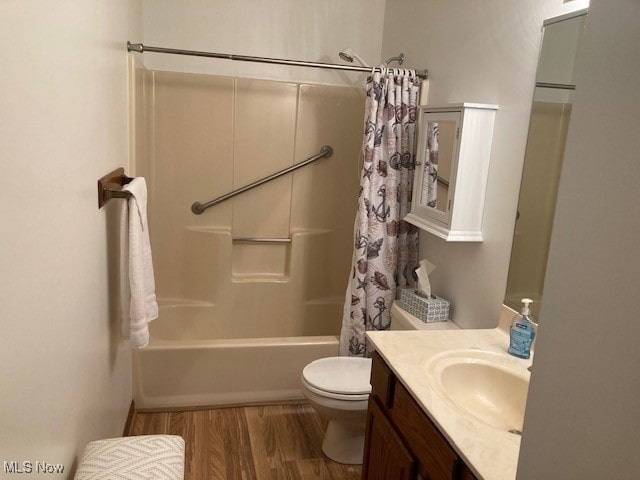 703 Tournament Trl, Cortland, OH 44410 - bathroom featuring vanity, wood finished floors, toilet, and shower / tub combo with curtain