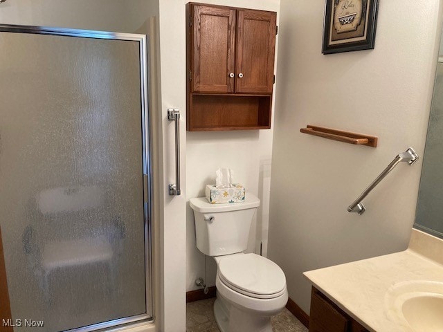 703 Tournament Trl, Cortland, OH 44410 - bathroom featuring toilet, a shower stall, baseboards, and vanity
