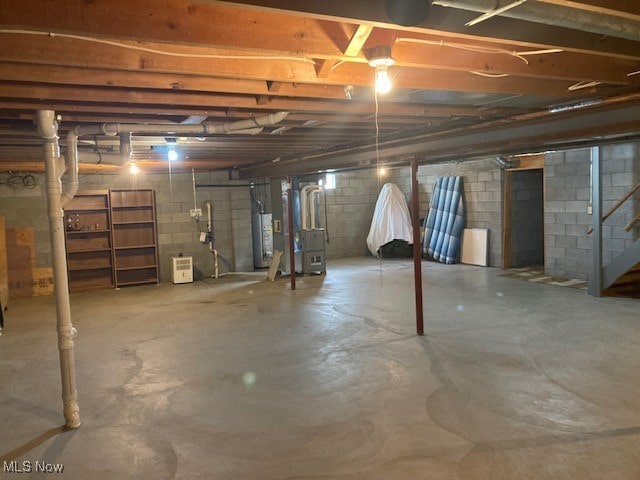 703 Tournament Trl, Cortland, OH 44410 - unfinished below grade area featuring water heater and stairway