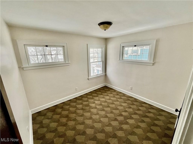 empty room featuring baseboards