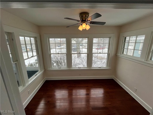 unfurnished sunroom with a ceiling fan and a wealth of natural light