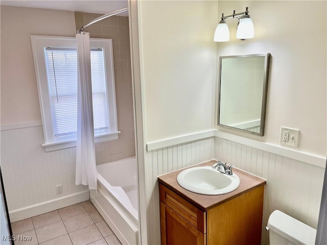 full bath featuring toilet, a wainscoted wall, vanity, and tile patterned floors