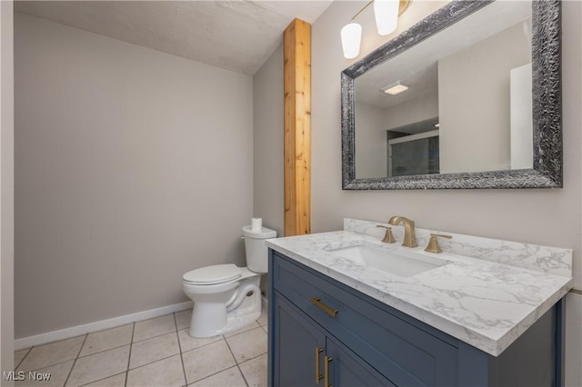 full bath with tile patterned flooring, toilet, vanity, baseboards, and a shower stall