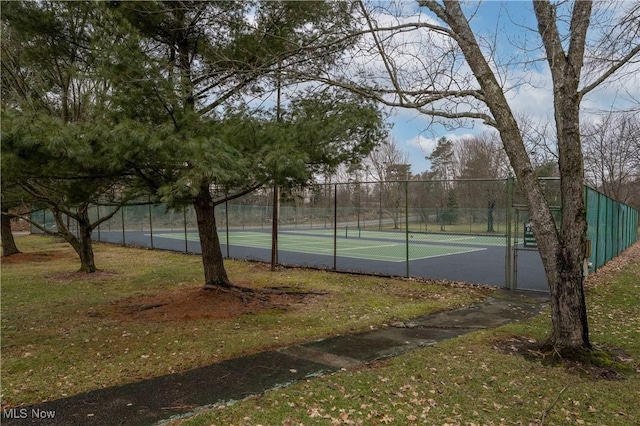 view of sport court with fence and a gate