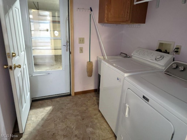 laundry room with cabinet space, baseboards, and separate washer and dryer