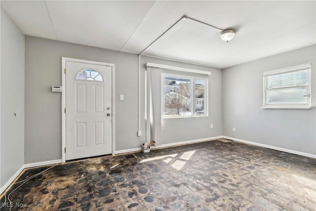 foyer featuring baseboards