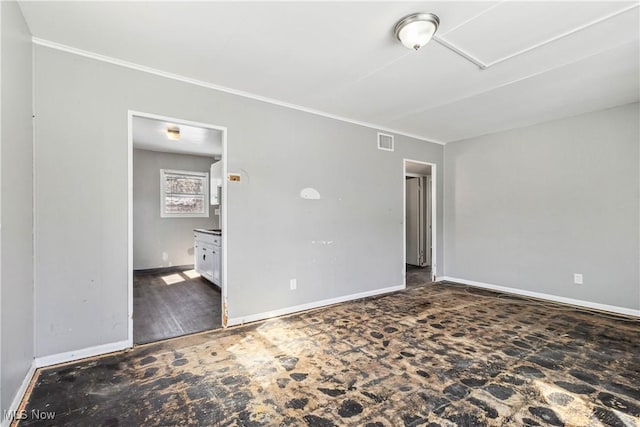 unfurnished bedroom featuring baseboards, visible vents, and ornamental molding