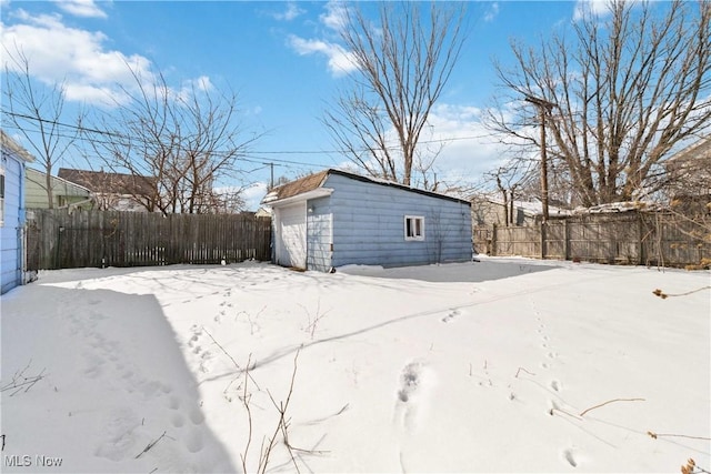 exterior space featuring a fenced backyard and an outbuilding