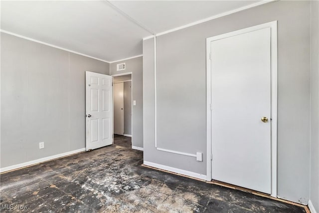 unfurnished bedroom with visible vents, crown molding, and baseboards